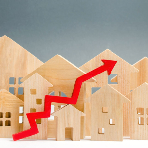 Petites maisons en bois avec une courbe représentant l'inflation